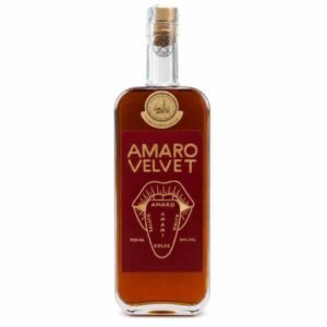 Bottle of Amaro Velvet liqueur with amber liquid and a red label, standing upright with a cork stopper.